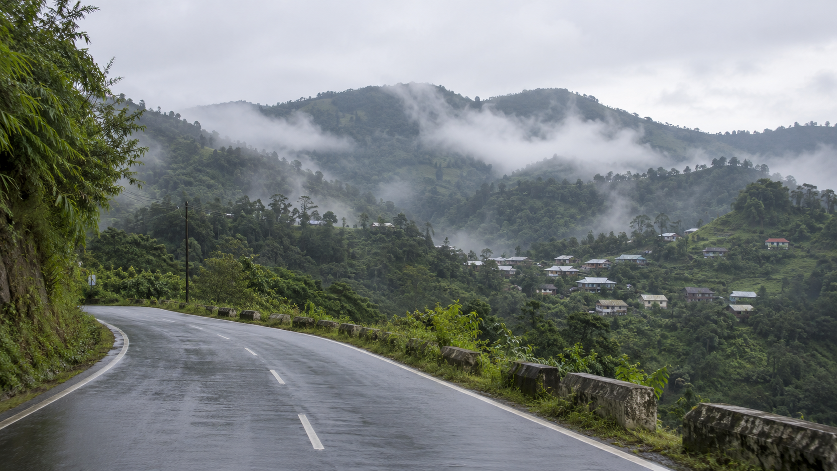 AI-generated editorial imagery of a generic northeastern Indian hillside road; not a photograph of the Manipur violence.
