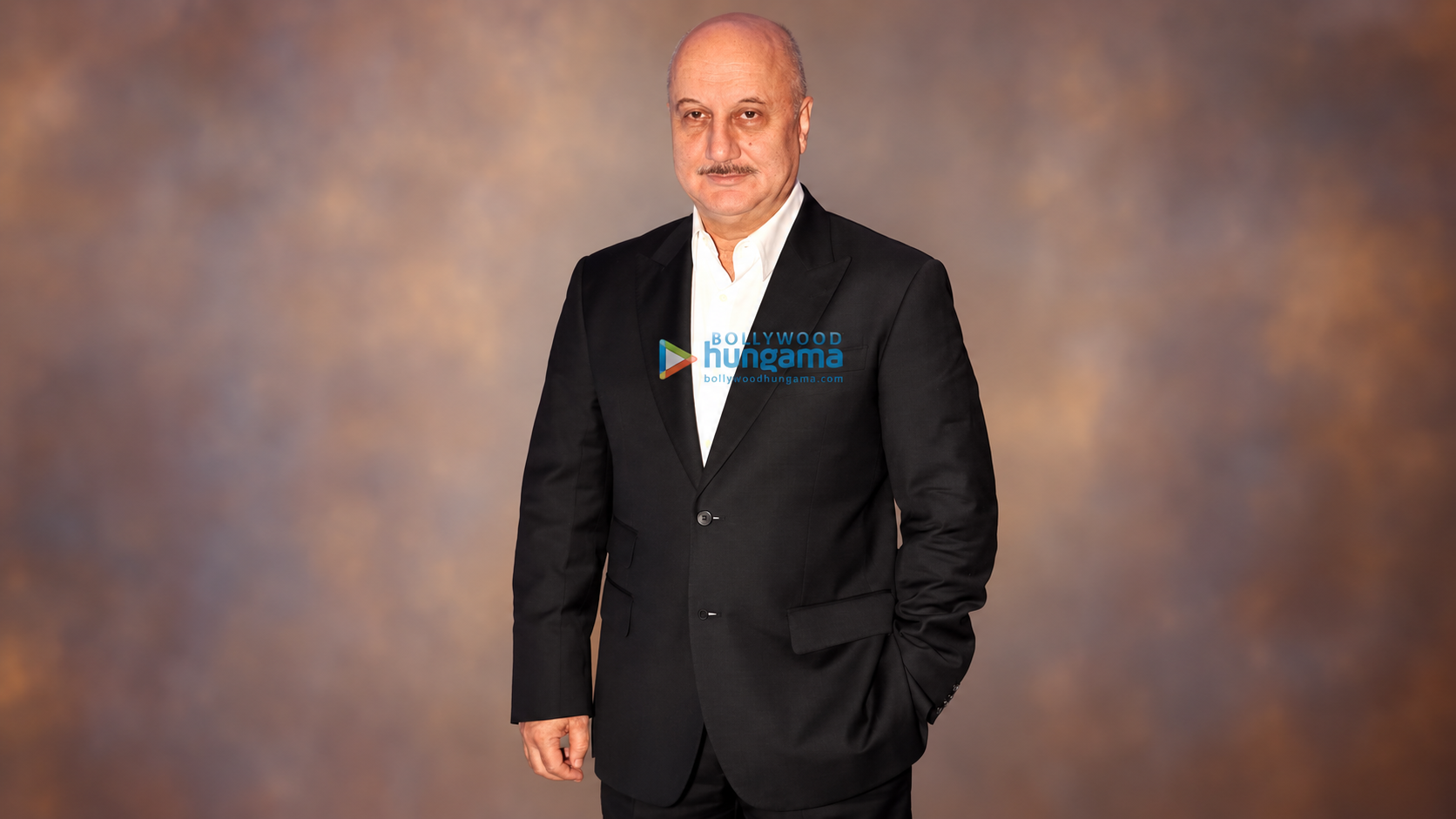 AI-modified archive photograph of Anupam Kher from 8 May 2013; not the Out of Fashion set or an endorsement.
