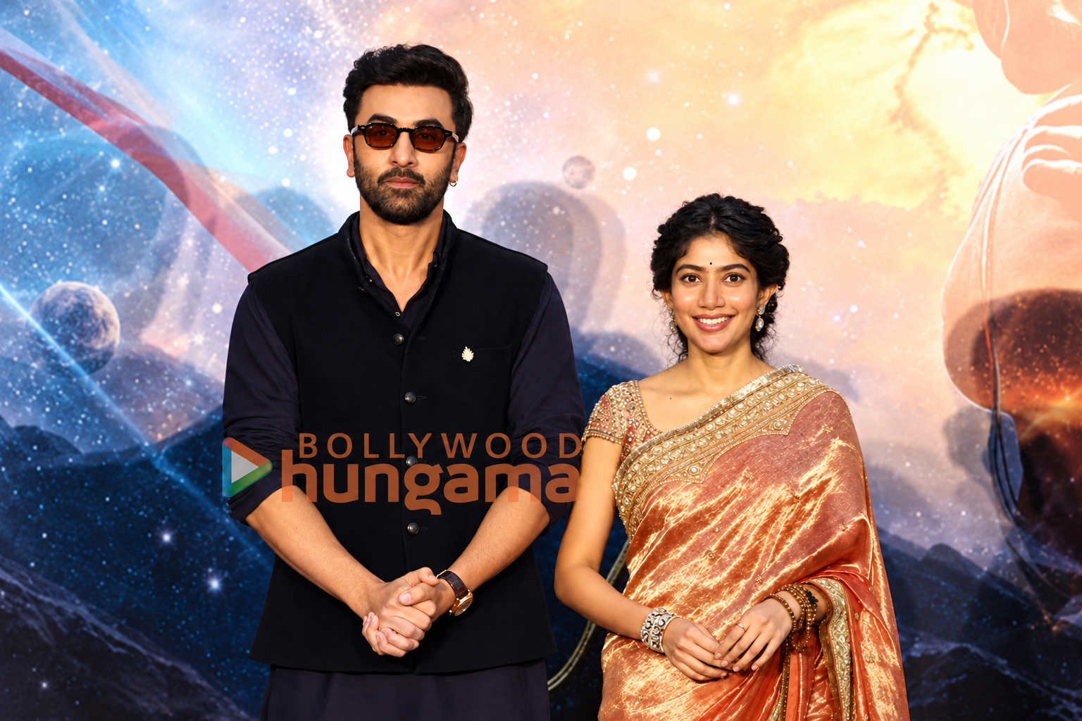 AI-modified archive photograph of Ranbir Kapoor and Sai Pallavi at a September 26, 2026 event, credited to Bollywood Hungama; not the October 11 announcement.